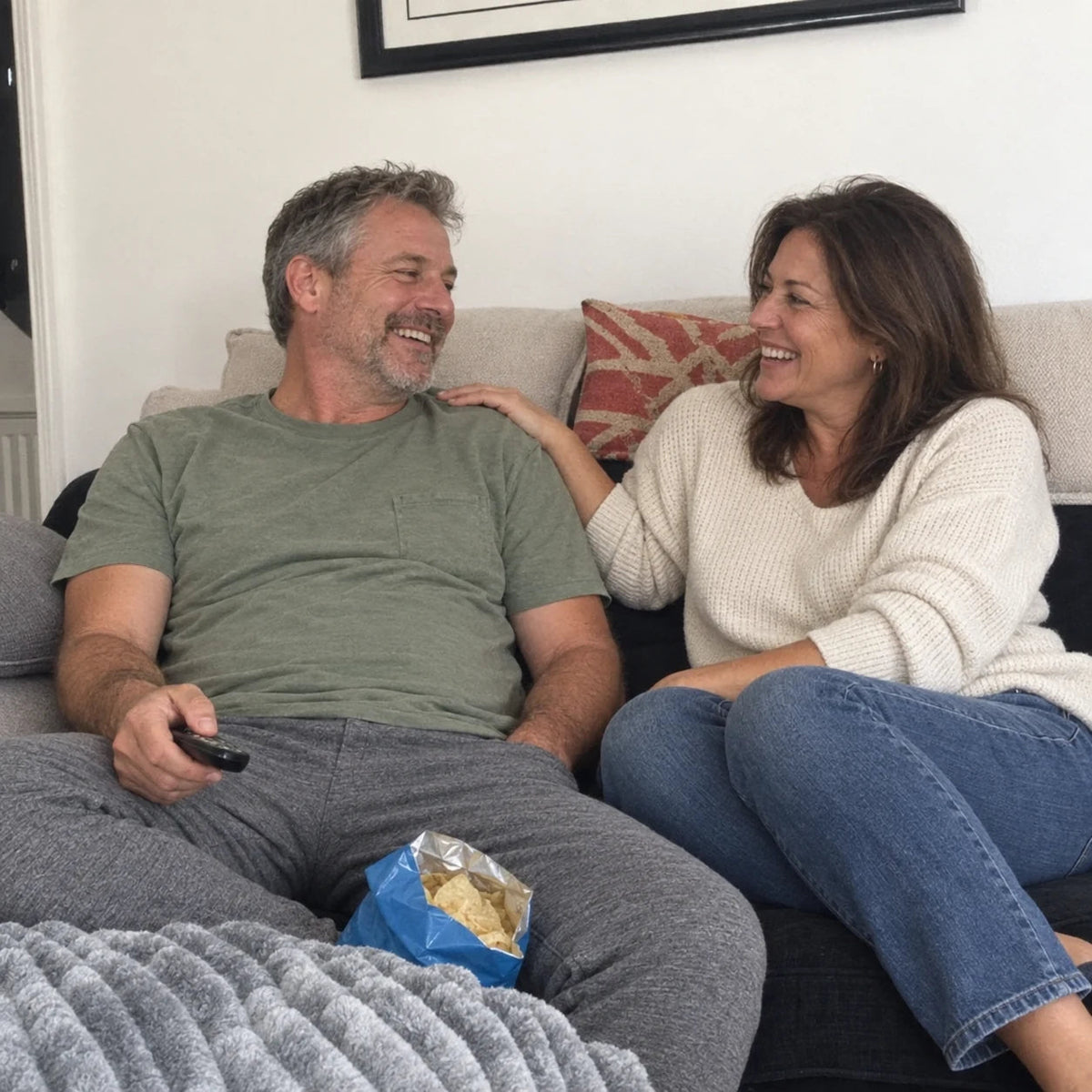 A couple relaxing together on the sofa.